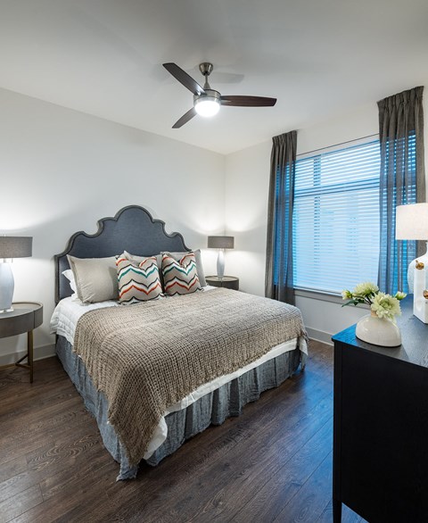 a bedroom with a bed and a ceiling fan