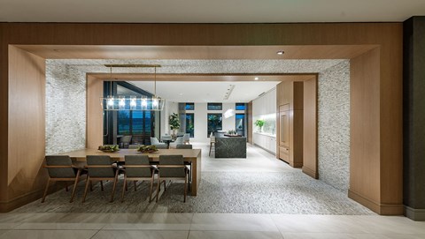 a long dining room with a long table in the middle