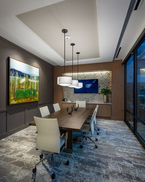 a conference room with a wooden table and chairs