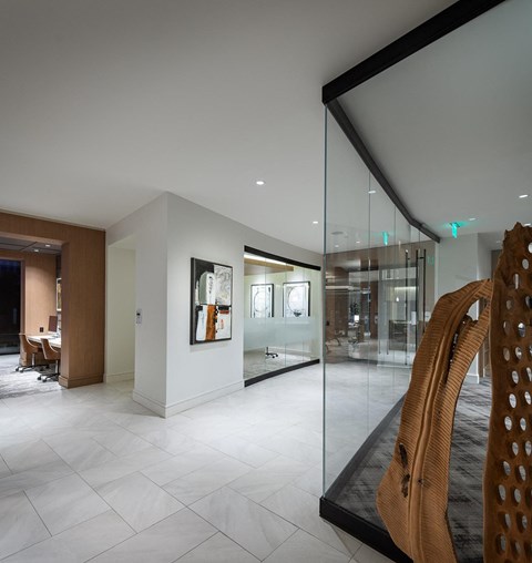a view of a lobby with a glass door and a chair
