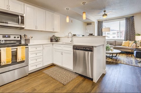 a kitchen with stainless steel appliances and white cabinets