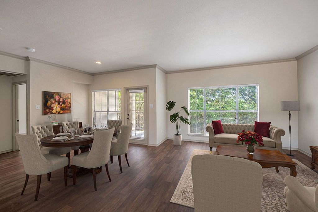 a living room and dining room with a table and chairs