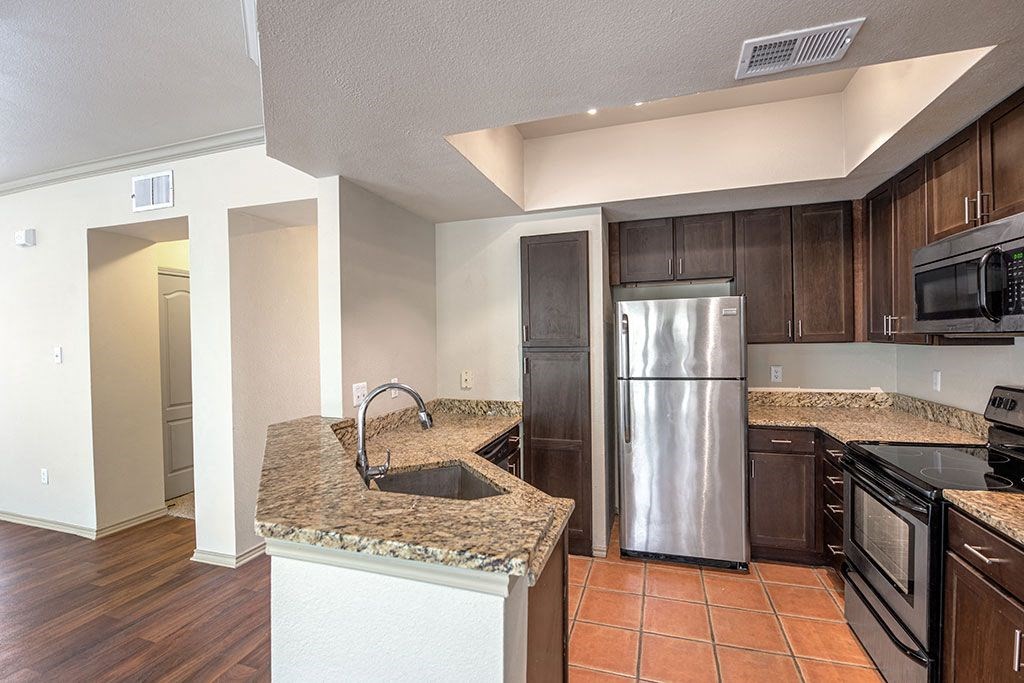 a kitchen with stainless steel appliances and granite counter tops
