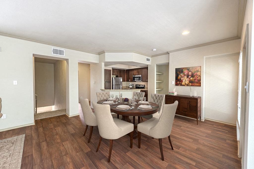 a dining room and kitchen with a table and chairs