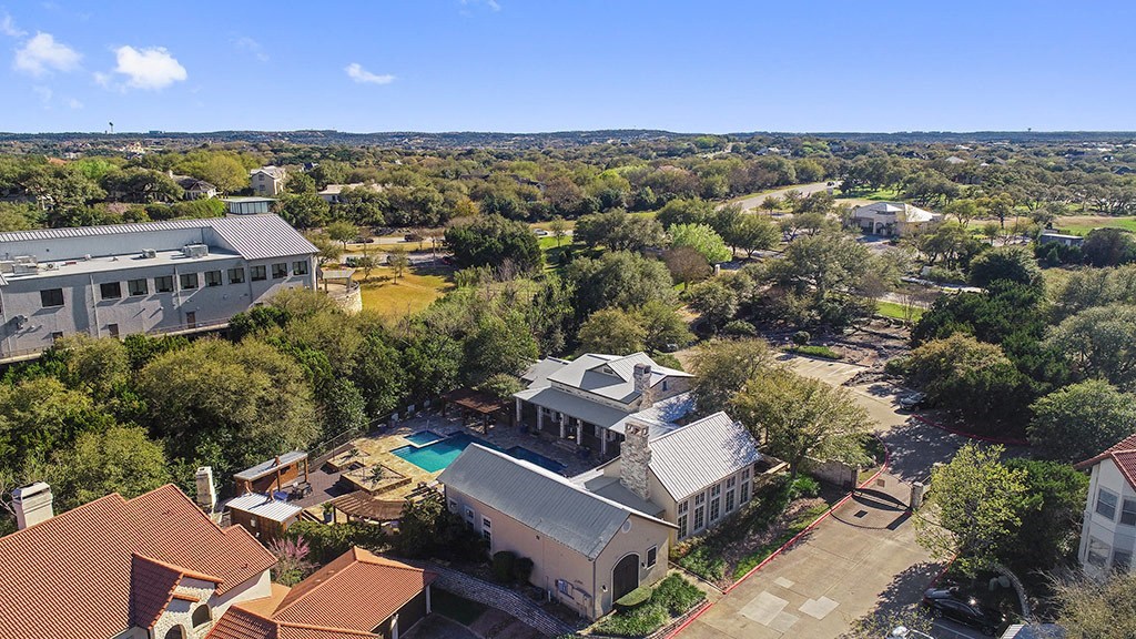 a birds eye view of a house with a pool and buildings