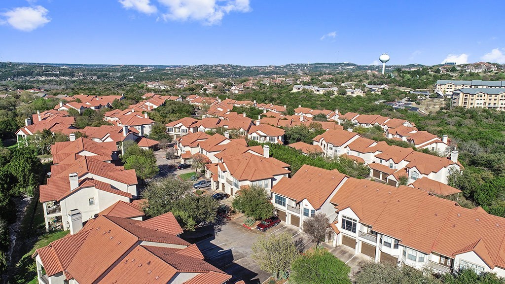 an aerial view of a neighborhood with houses and a water tower