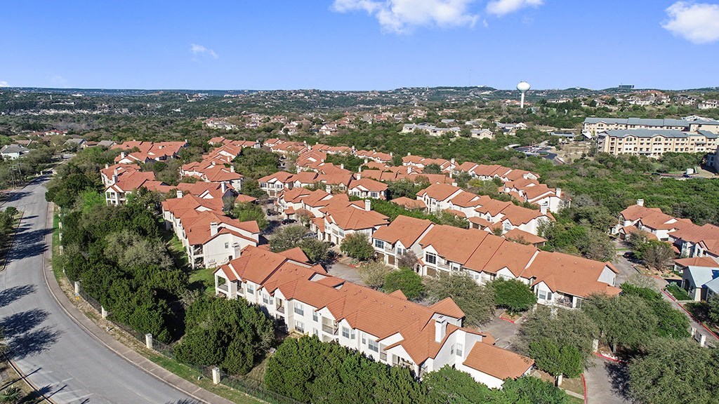 an aerial view of a neighborhood with houses and trees