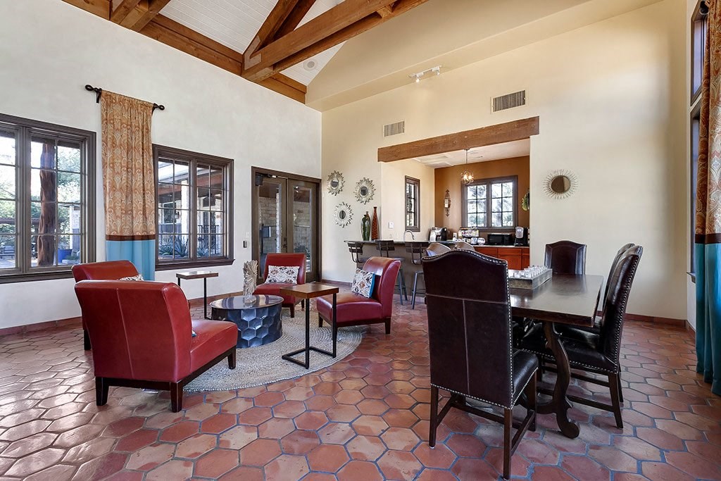 a living room and dining room with a table and chairs