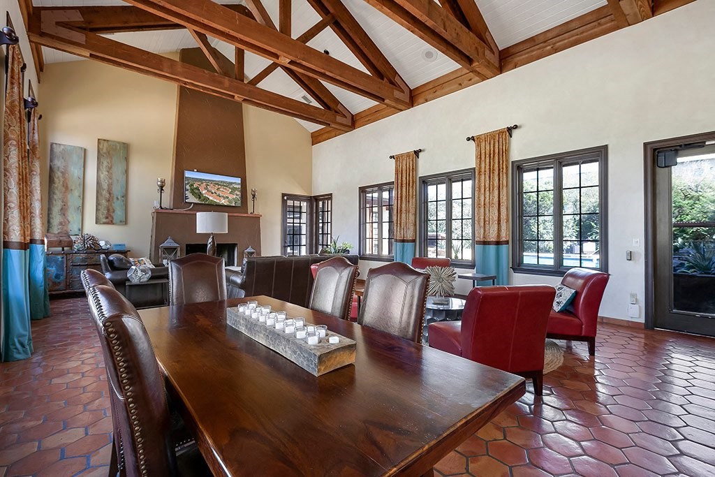 a large dining room with a wooden table and chairs