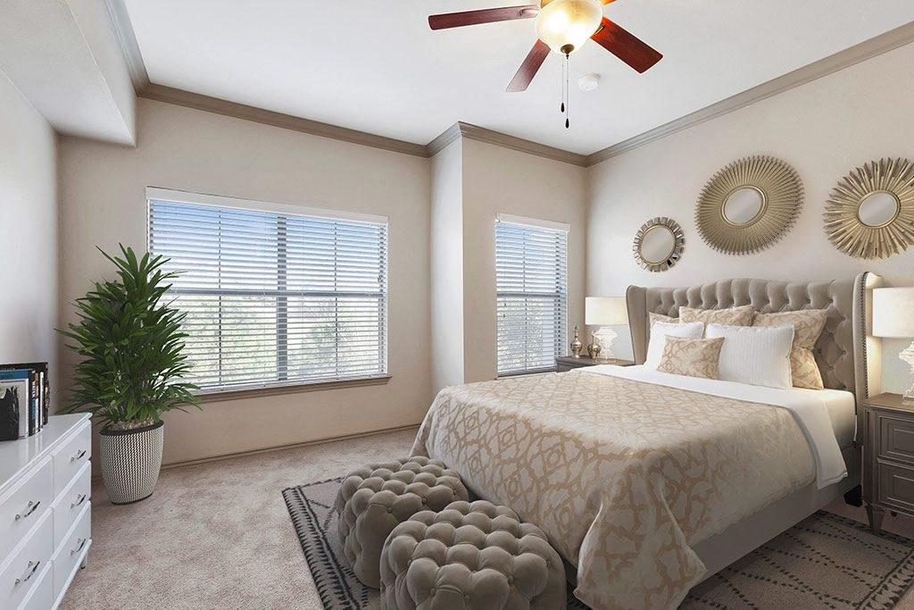 a bedroom with a bed and a ceiling fan