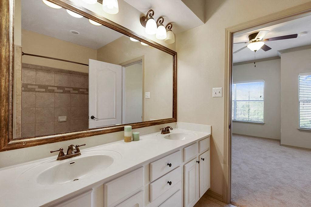 a bathroom with two sinks and a large mirror