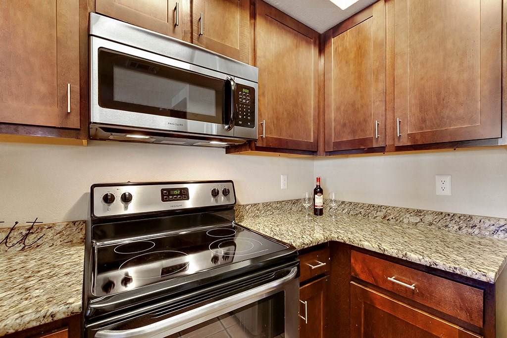 a kitchen with stainless steel appliances and granite counter tops