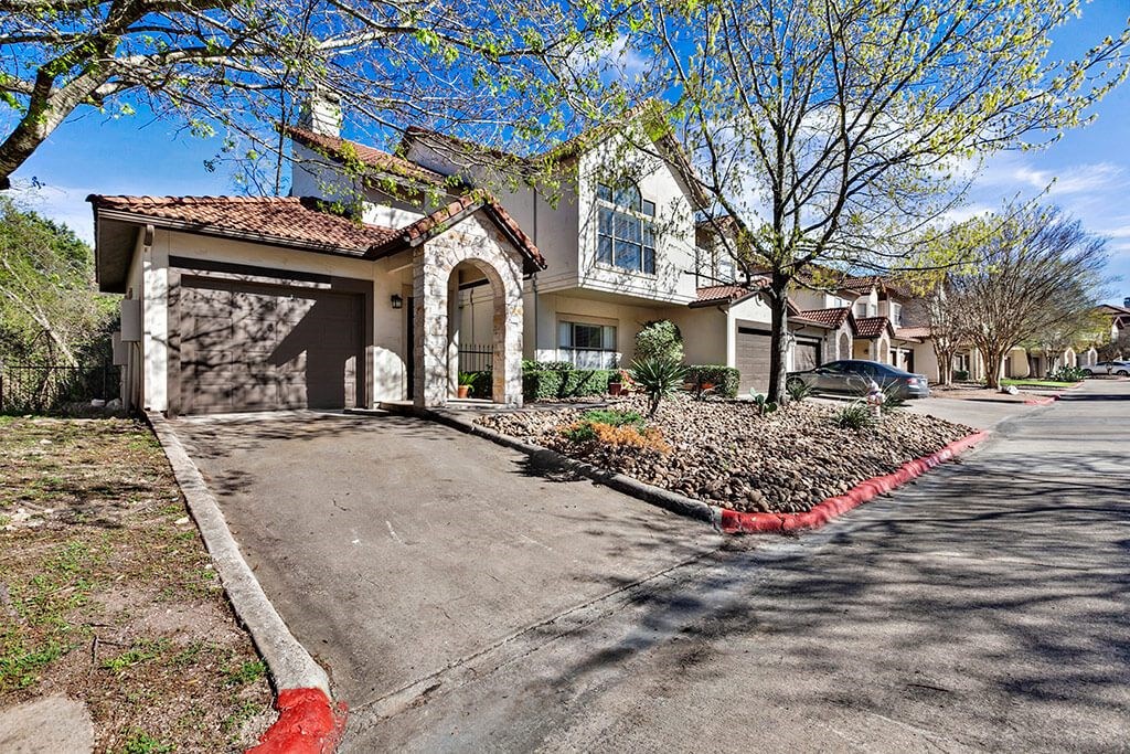 the front of a house with a driveway and a garage door