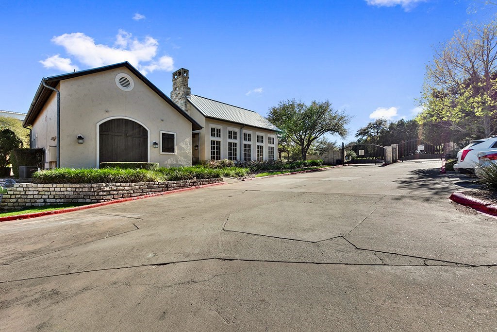 a parking lot in front of a church with a driveway