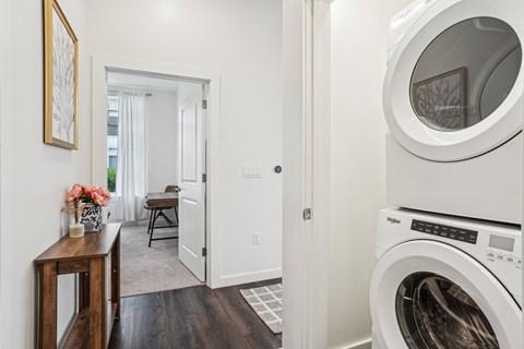 a white washer and dryer in a laundry room with a door to a