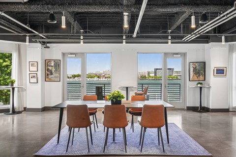 A conference room with a long table and chairs.
