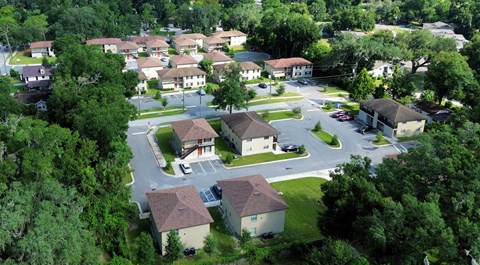 A bird's eye view of a residential neighborhood with houses and trees.