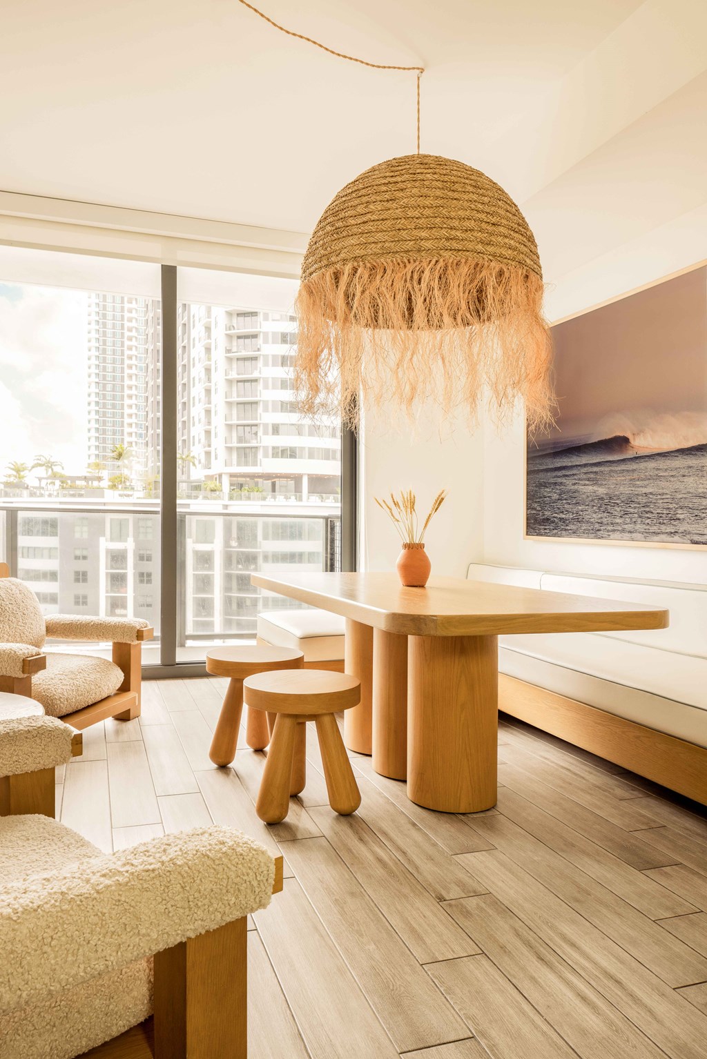 A room with a table, chairs, and a hanging decoration.