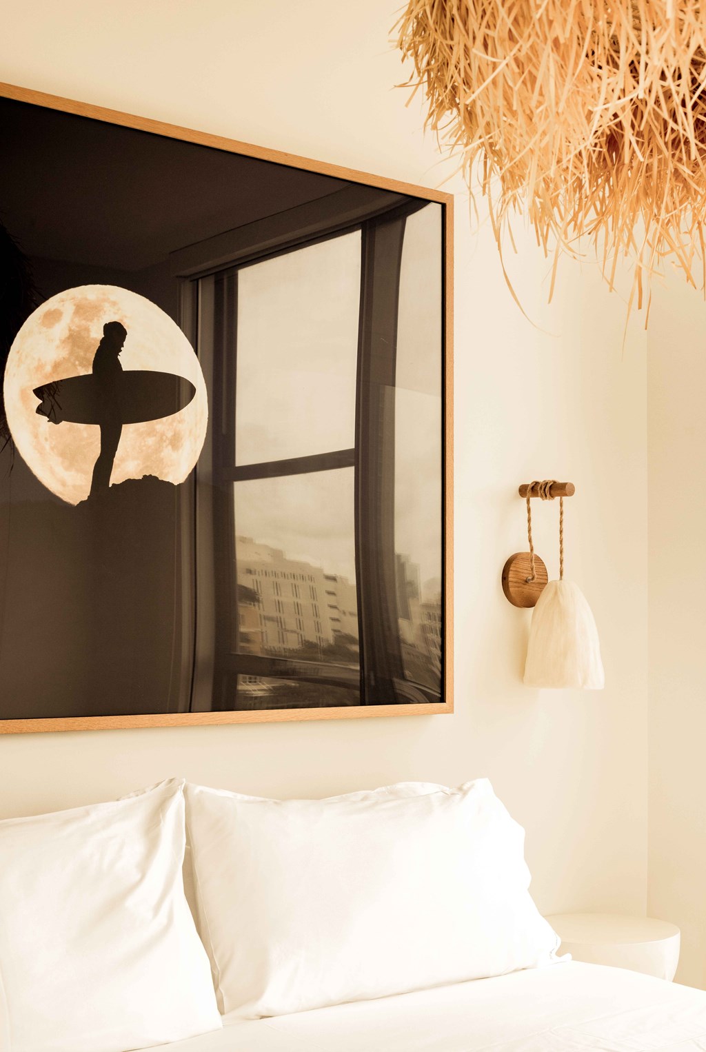 A surfer silhouette is on a wall above a window.