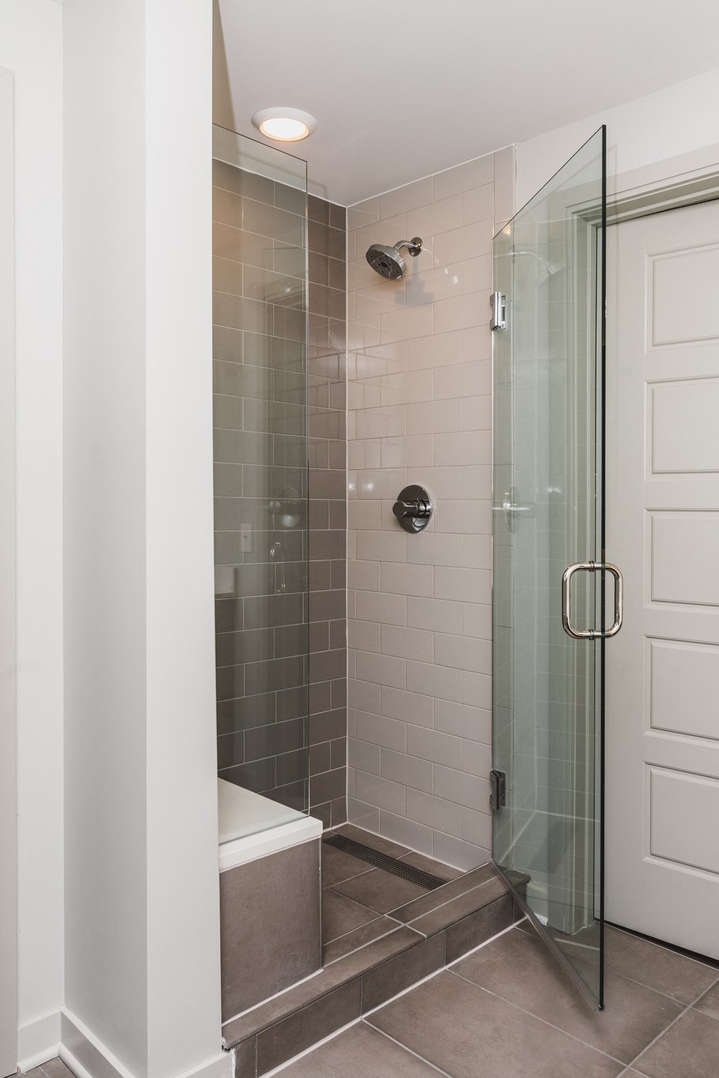 a walk in shower with a glass door