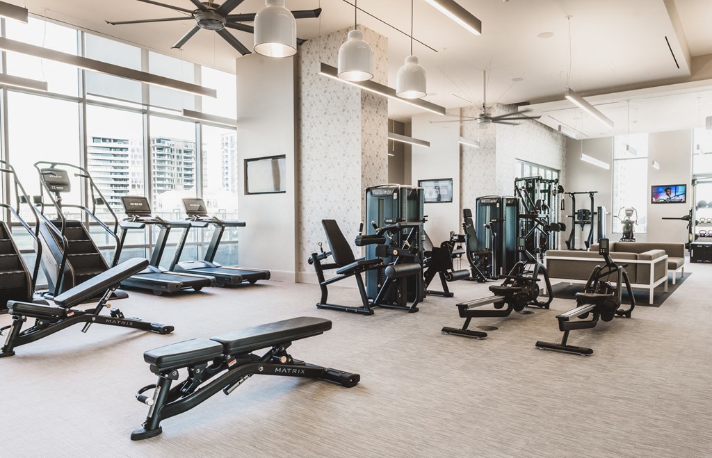 a large fitness room with treadmills and other exercise equipment