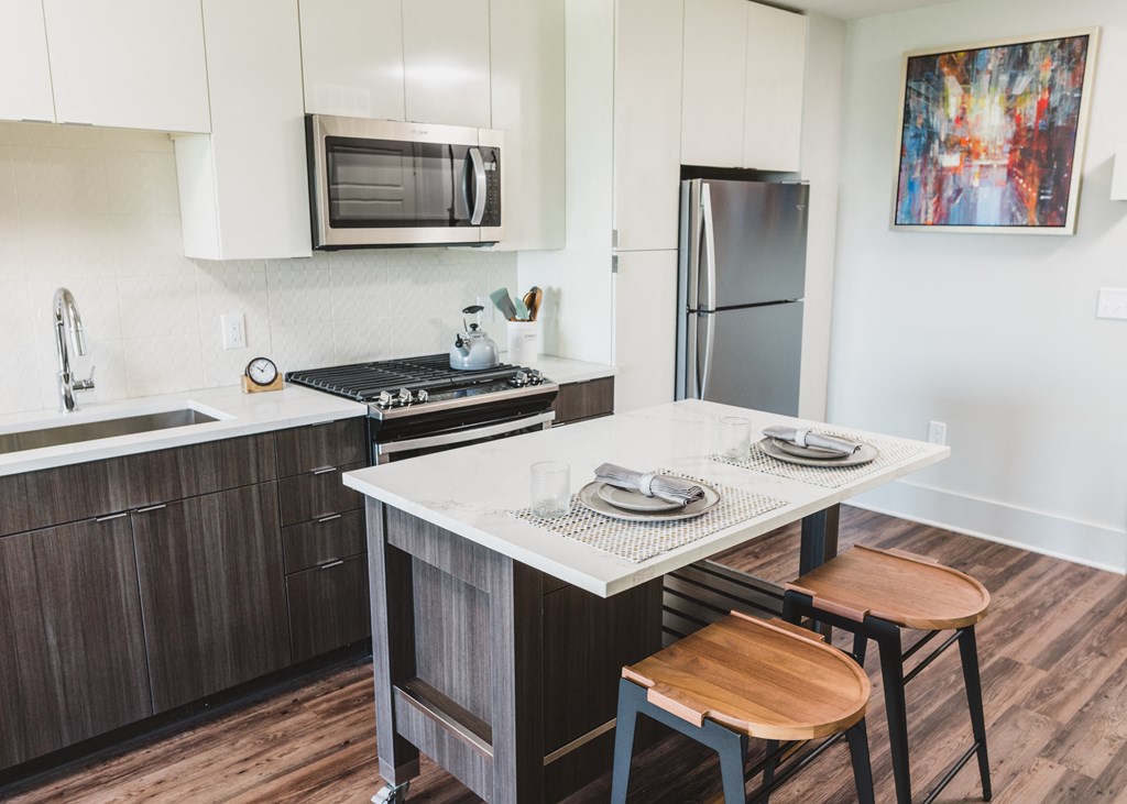 a kitchen with a center island with two stools