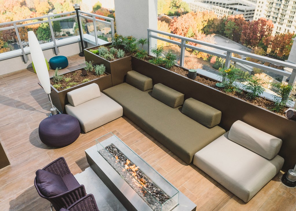 a terrace with a couch and a fire pit