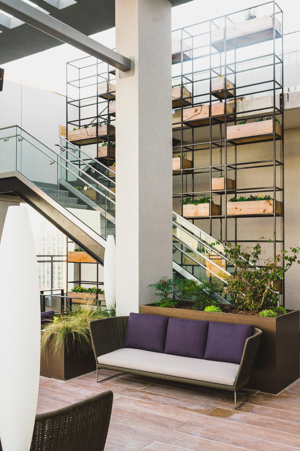 a seating area with a couch and a chair in front of a staircase