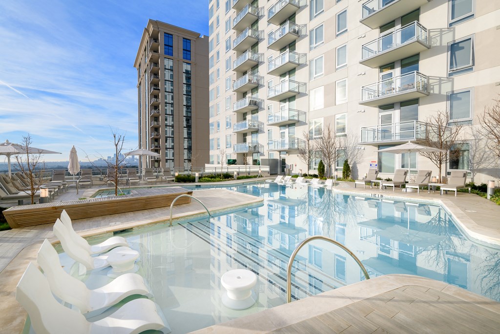 an outdoor pool with a large building in the background