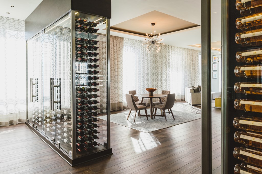 a dining room with a table and chairs next to a wine cellar