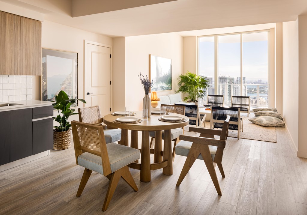 A modern dining room with a round table and chairs.