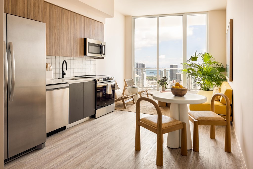 A modern kitchen with a dining table and chairs.