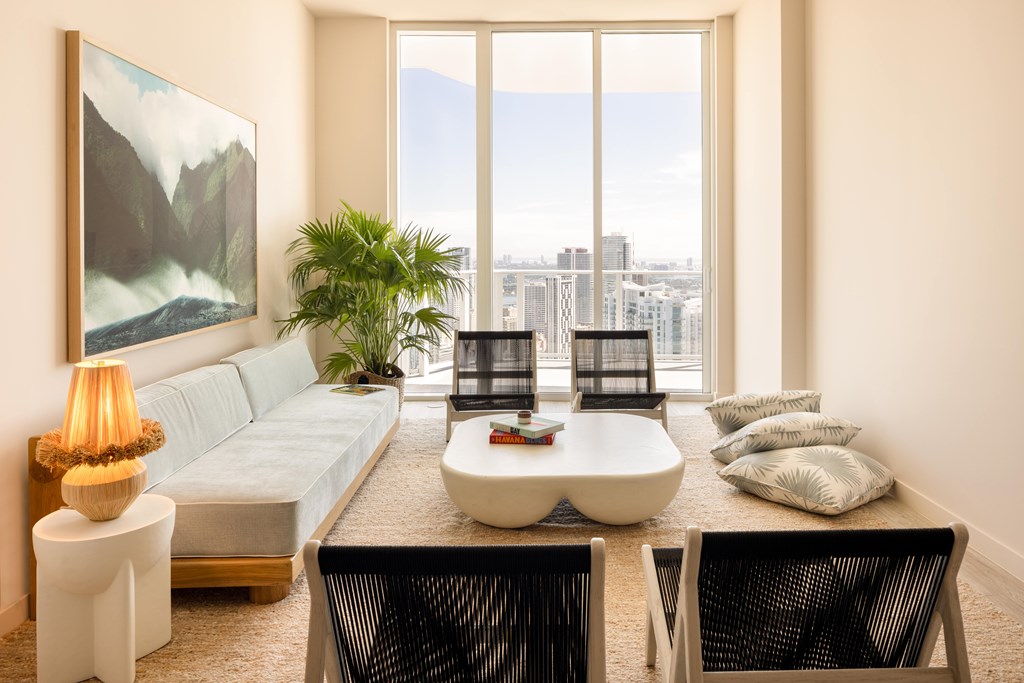 A modern living room with a large window overlooking the city.