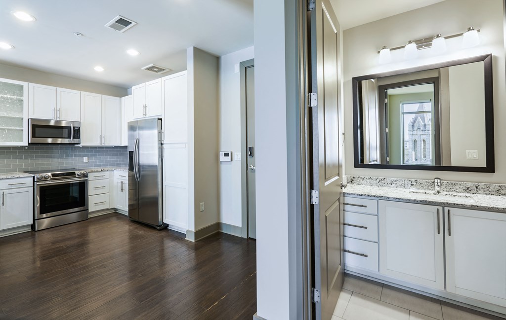a kitchen with white cabinets and stainless steel appliances