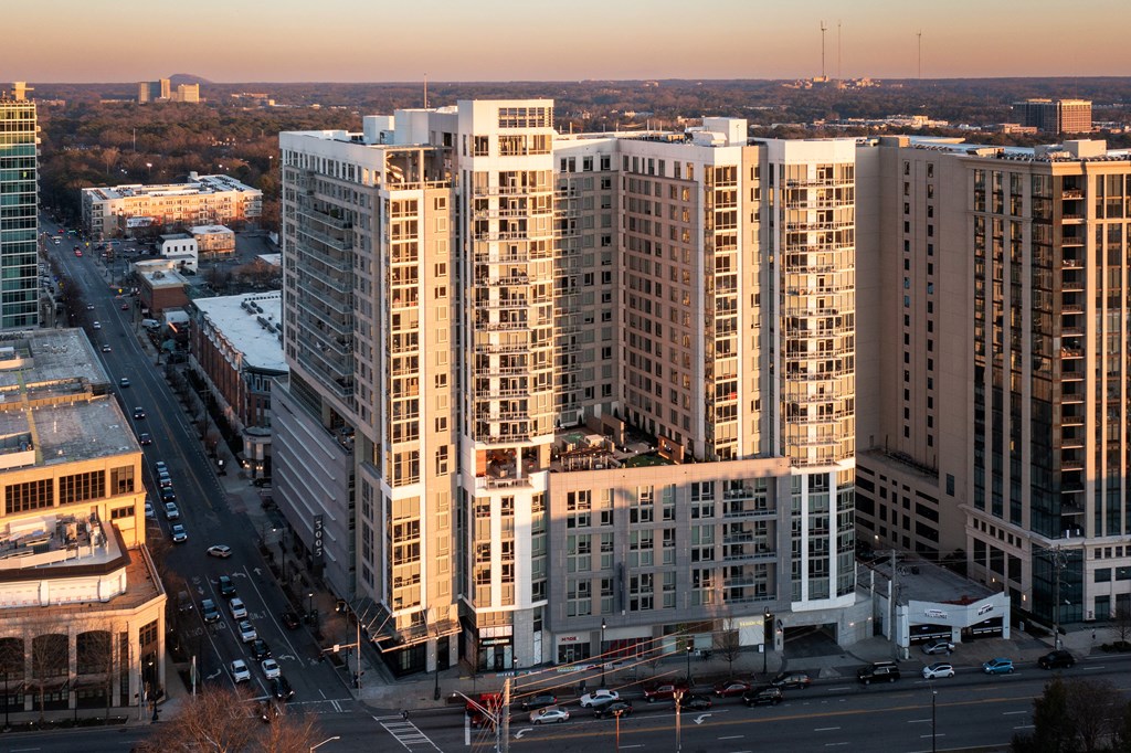 a group of tall buildings in a city at sunset