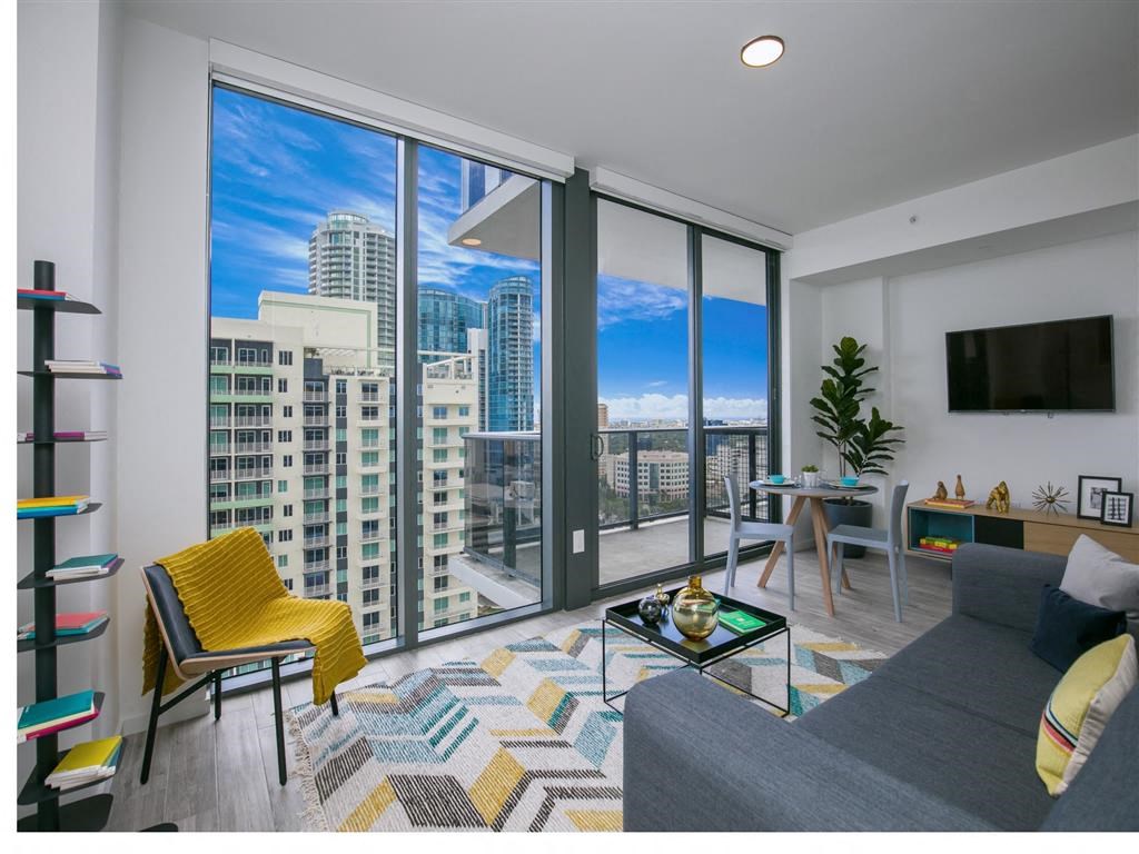 a living room with a view of the city and skyscrapers