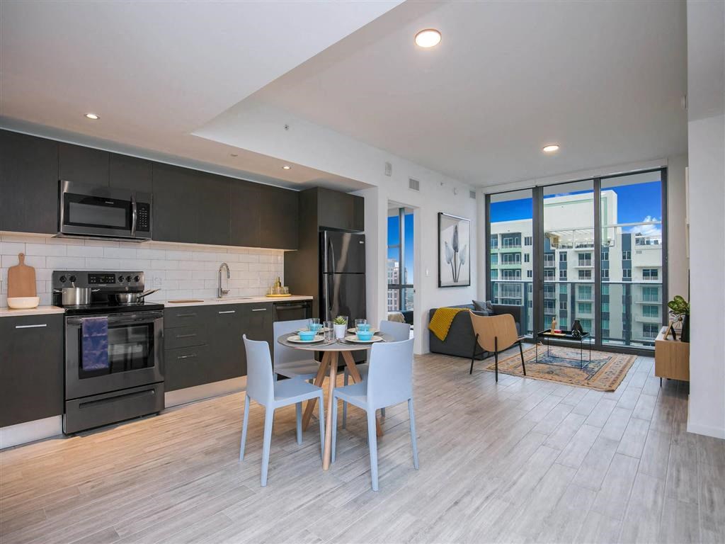 a kitchen and dining area with a large window
