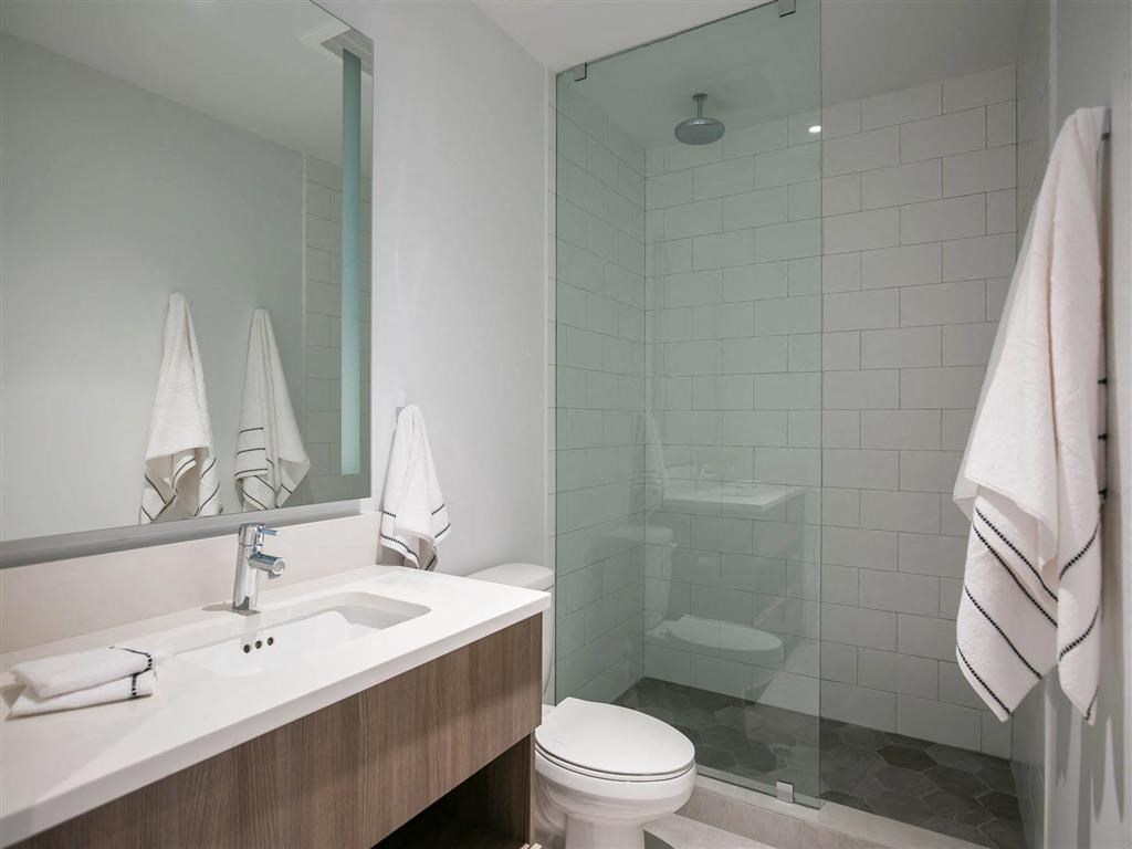 a bathroom with a toilet and a sink and a shower