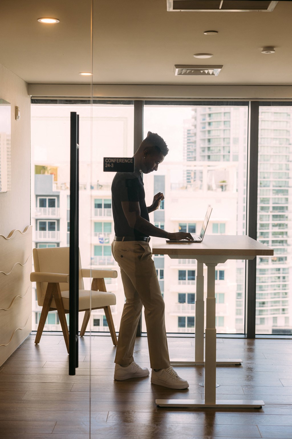 a man standing in front of a laptop computer on a desk
