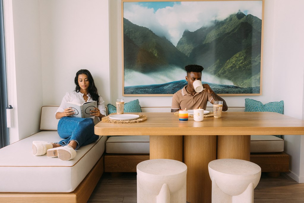 a man and a woman sitting at a table in a room