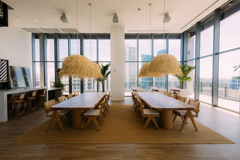 a dining room with large windows and a table and chairs