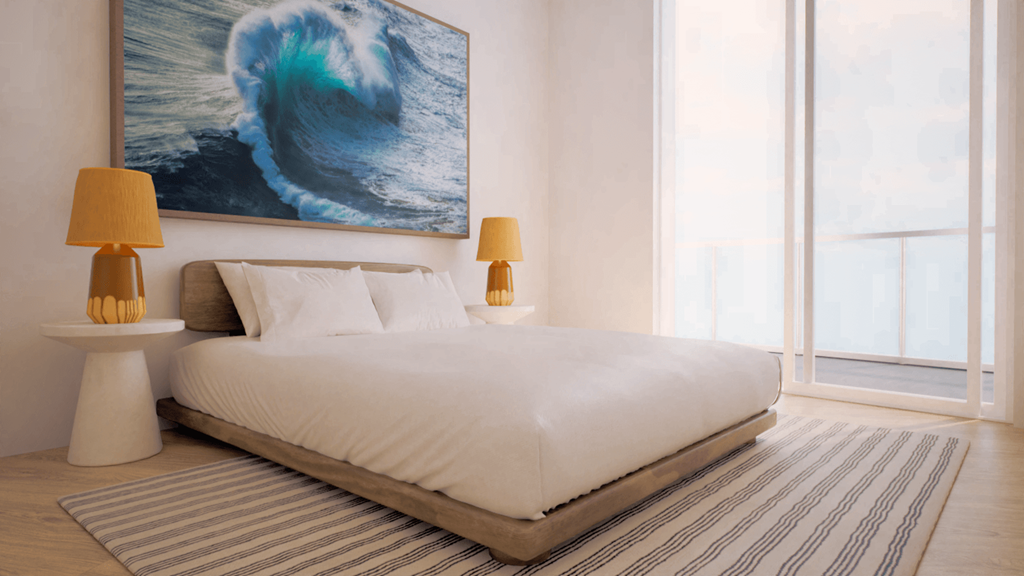 A bedroom with a large bed and a painting of a wave on the wall.