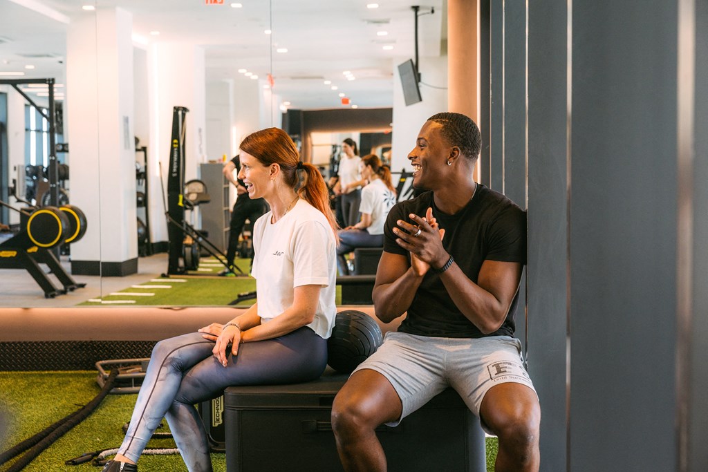 a man and a woman talking in a gym