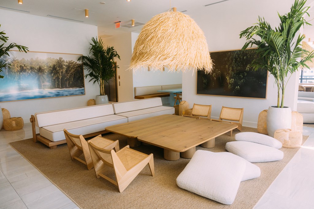 a living room with a large wooden table and chairs