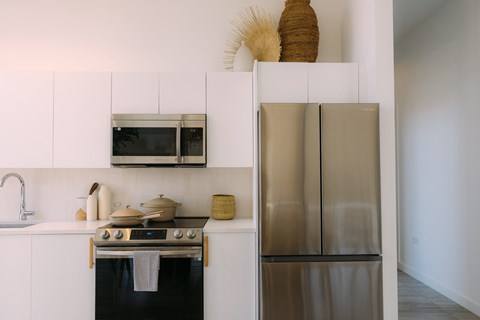 a kitchen with stainless steel appliances and white cabinets