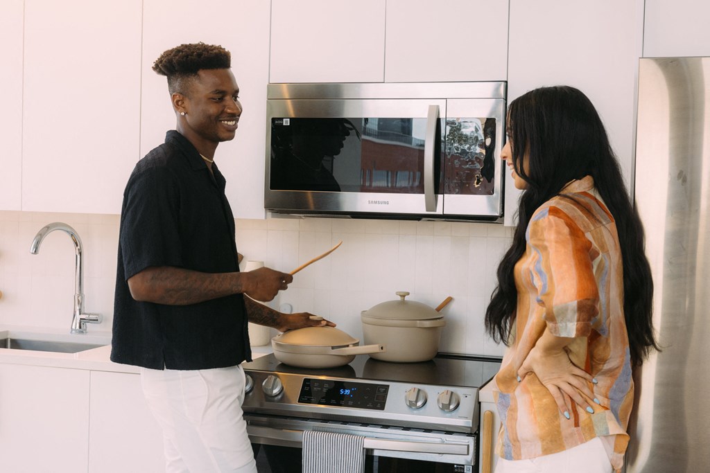 a man and a woman cooking in a kitchen