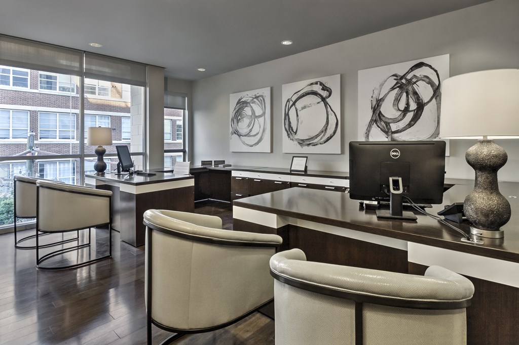 an office with a computer desk and chairs