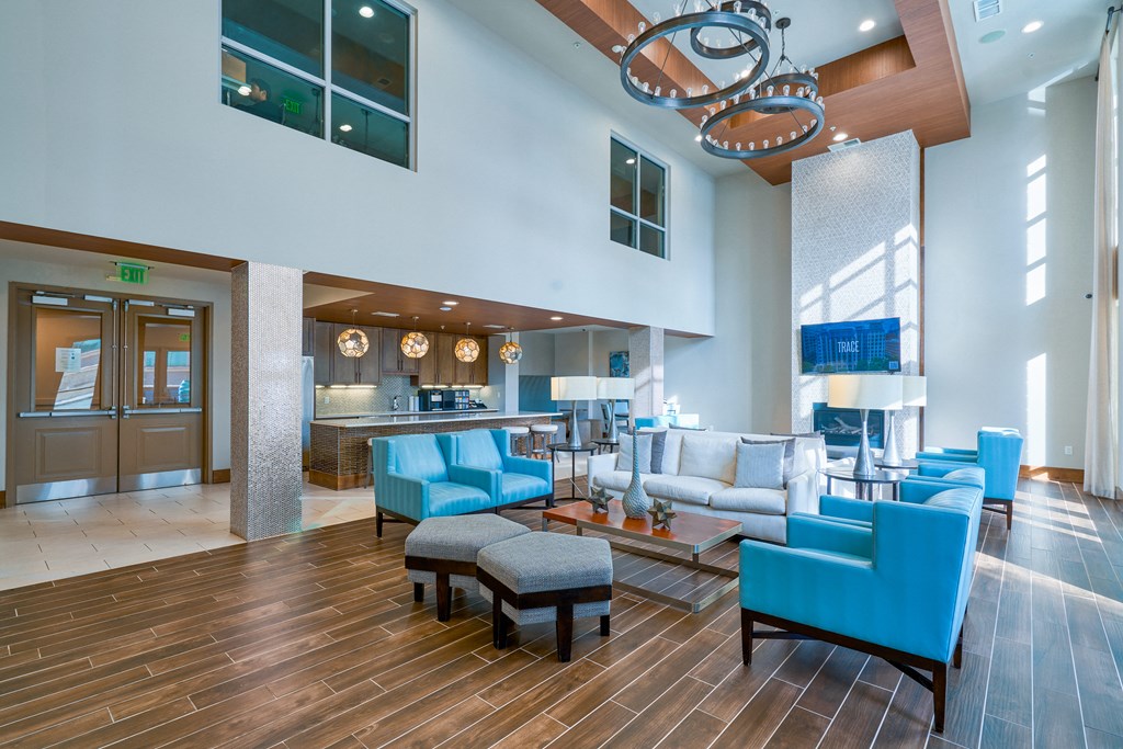a lobby with blue chairs and couches