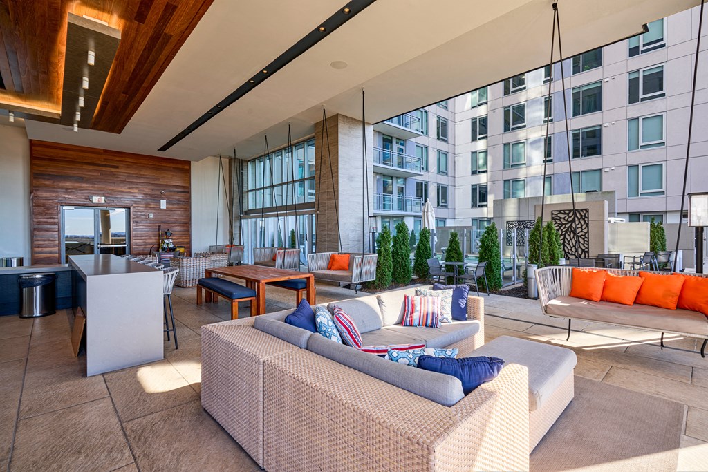 a living room with couches and chairs and a table in front of a building