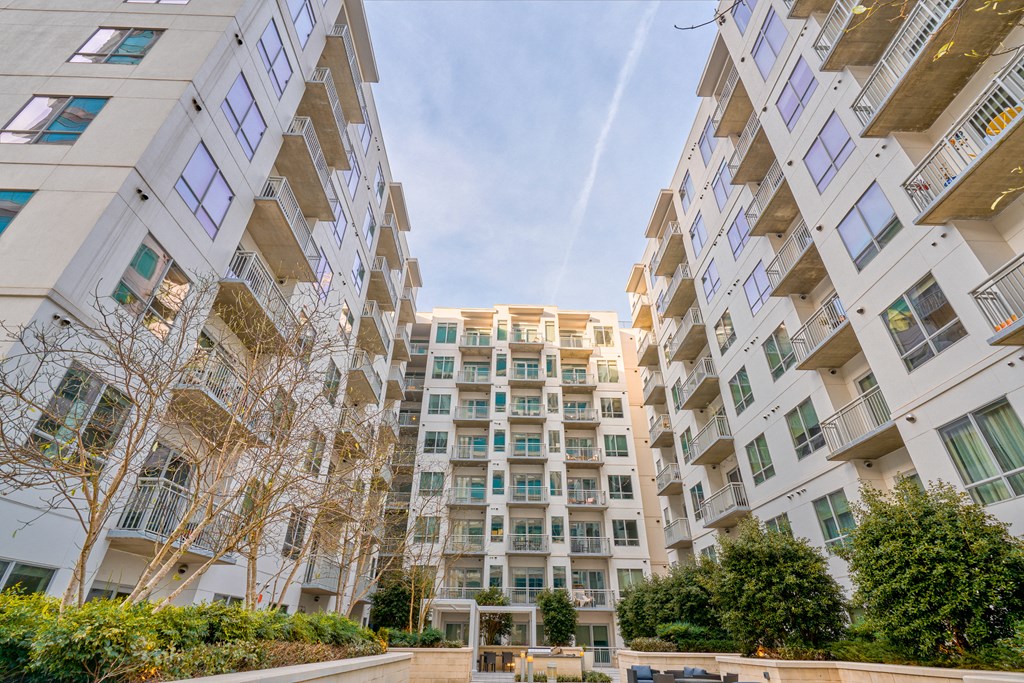 an apartment building with many windows and a street in front of it